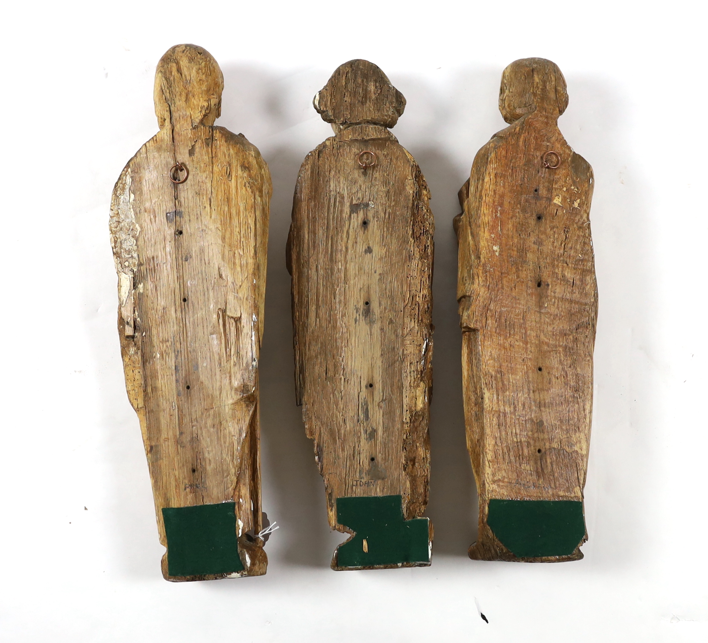 A set of three 18th century Continental carved wood figures of Saints, largest 17cm wide, 58cm high